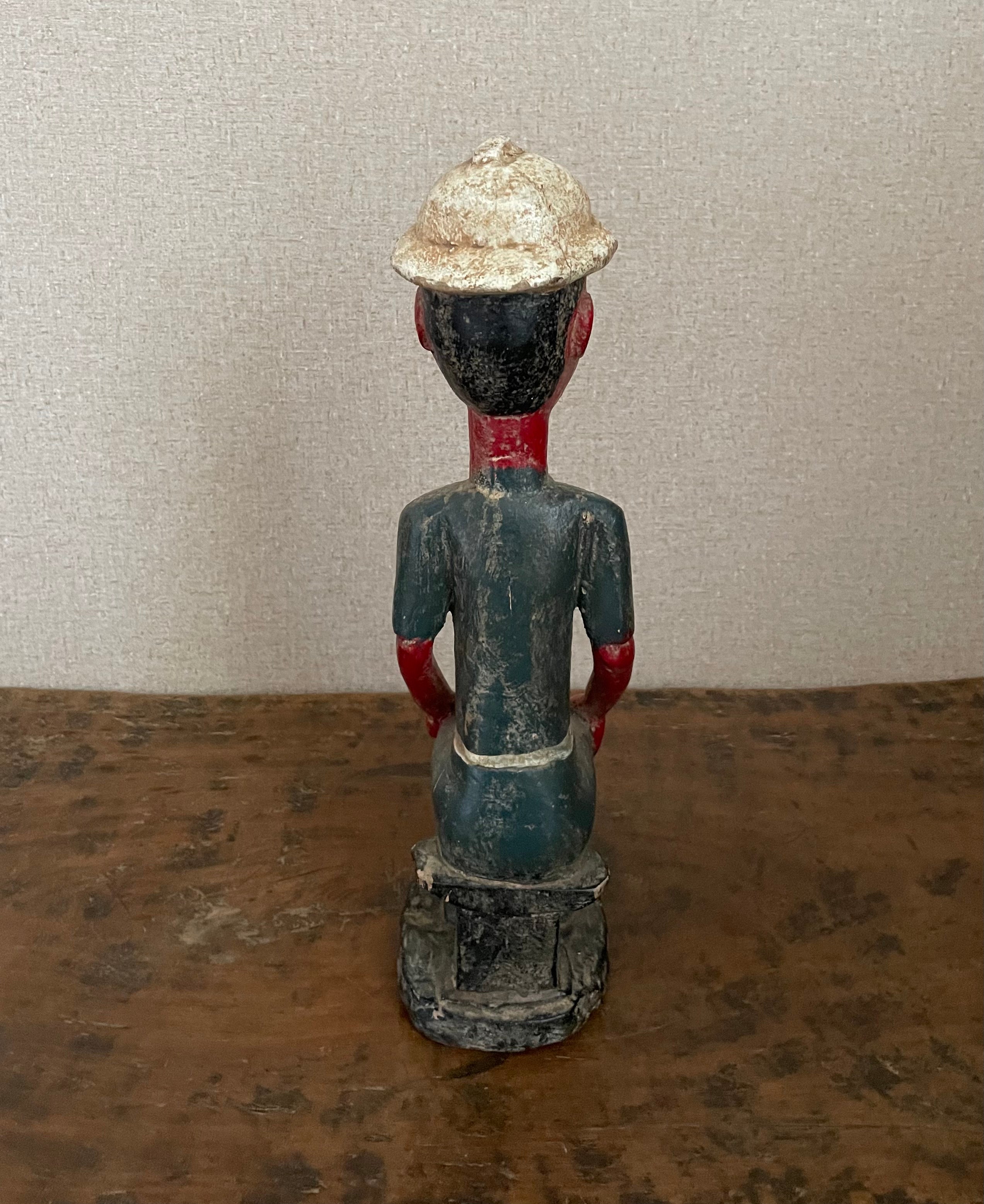 Handcrafted Sculptures - Collection - African Art - Sculptures Statues -  Artwork - Artisan Designed - Handcrafted - Home Decor - Office - Any Room - This vintage African Painted Seated Male Statue is crafted from quality wood, then painted to create a lifelike African sculpture. The perfect addition to your home décor, it measures 15
