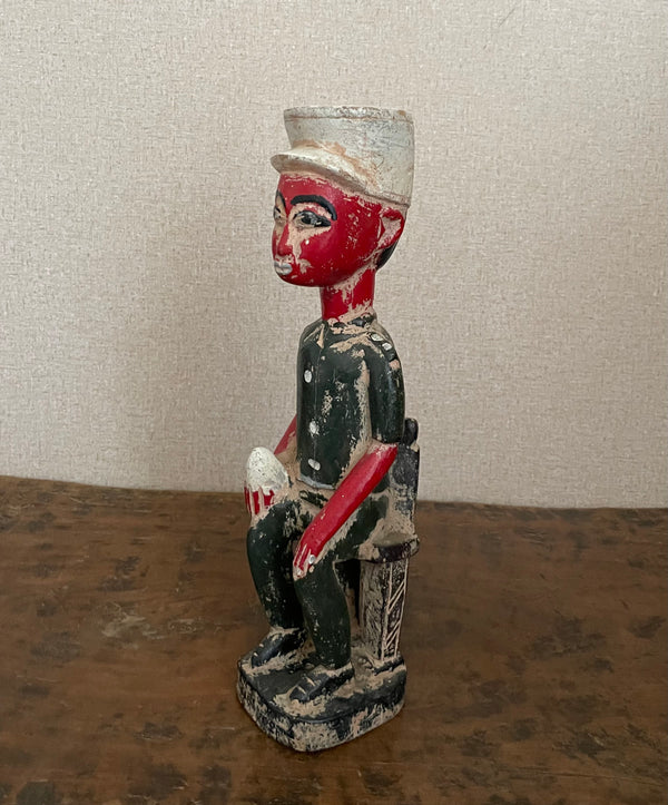 Handcrafted Sculptures - Collection - African Art - Sculptures Statues - Artwork -  Artisan Designed - Handcrafted - Home Decor - Office - Any Room - This decorative wooden statue is a unique and stylish addition to any home. Hand painted with an authentic African design, the Seated Man African Statue is beautiful and one of a kind. Its vintage look adds character and charm to your home. Length: 13 inches Width: 2.5 inches
