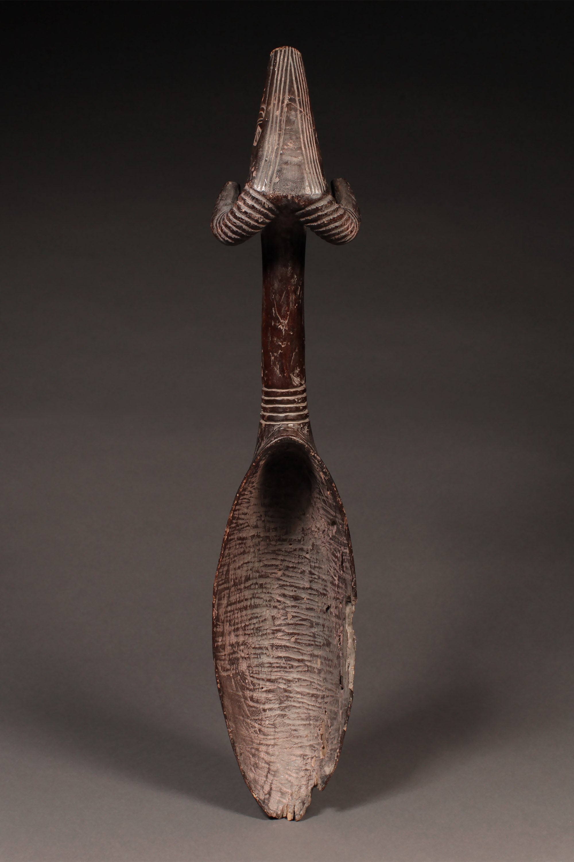 Tribal Objects - African Tribal Art - Ancient Ceremonial Art - Handcrafted Artifacts - Masks - Wood Sculptures - Iron Bronze Objects - Textiles - Art Pieces - African Folk Art - This rare and authentic Ceremonial Ladle Spoon from the Dan Tribe is carved from wood from the Ivory Coast and Liberia. It features a Ram's Head on the handle and is estimated to be very old. A true collector's item, perfect for those looking for an extraordinary cultural piece. 30