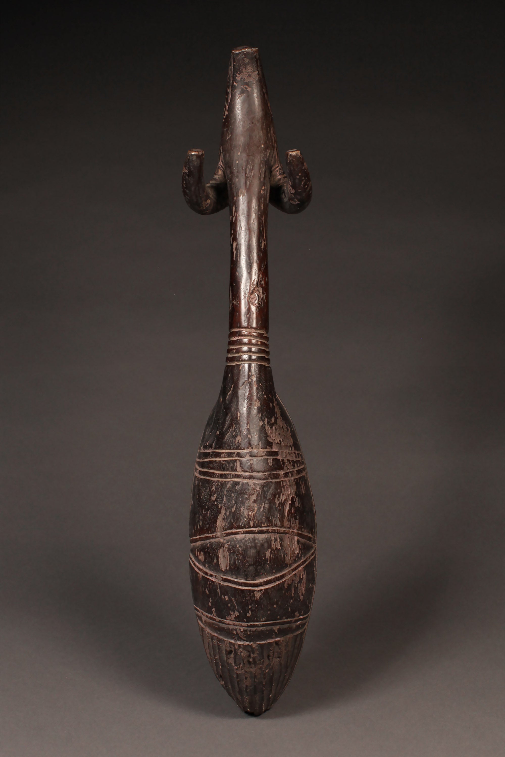 Tribal Objects - African Tribal Art - Ancient Ceremonial Art - Handcrafted Artifacts - Masks - Wood Sculptures - Iron Bronze Objects - Textiles - Art Pieces - African Folk Art - This rare and authentic Ceremonial Ladle Spoon from the Dan Tribe is carved from wood from the Ivory Coast and Liberia. It features a Ram's Head on the handle and is estimated to be very old. A true collector's item, perfect for those looking for an extraordinary cultural piece. 30