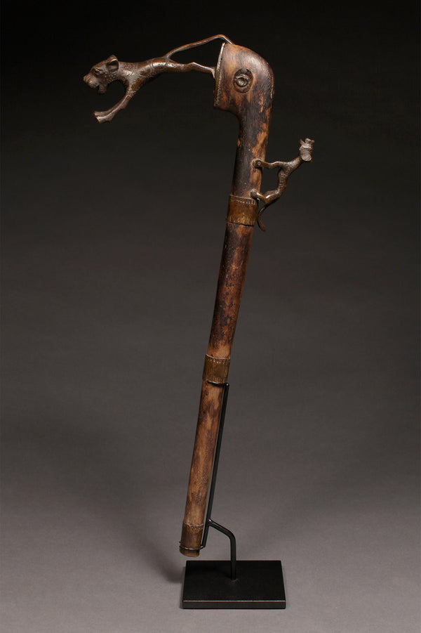 Tribal Objects - African Tribal Art - Ancient Ceremonial Art - Handcrafted Artifacts - Masks - Wood Sculptures - Iron Bronze Objects - Textiles - Art Pieces - African Folk Art - This Zoomorphic Prestige Staff Scepter is a stunning piece of African art. Carved by the Fon tribe of Republic of Benin, this scepter is made of wood, bronze, and brass. Highly sought after by collectors, this artifact is an exquisite example of tribal sculptures. Height: 23" Inventory # 10393