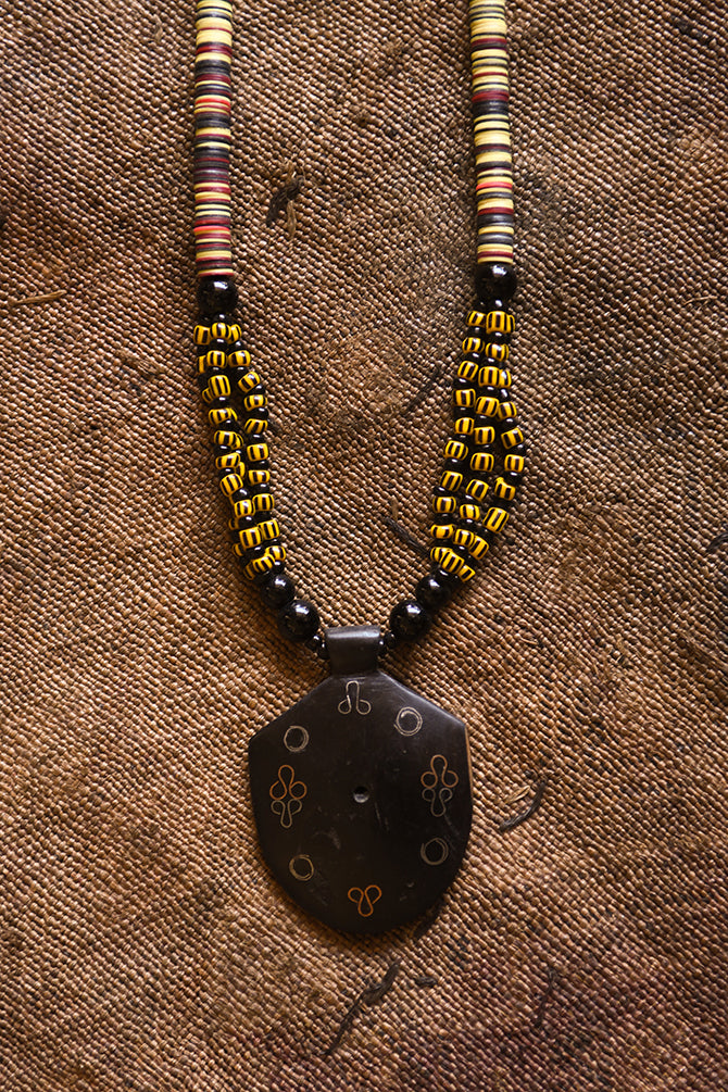 Handcrafted Necklaces - Handmade - African Art - Jewelry - Beaded Necklaces - This Tribal Beaded Jewelry Necklace is handmade from African vintage chevron trade beads, assembling a unique and exotic tribal style. Each bold pendant complements the look and feel of its wooden base, creating a timeless piece for any occasion. Length: 13