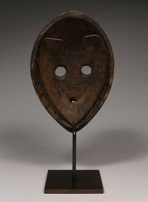 Tribal Masks - Handcrafted - Dan Masks - Traditional Folk Art - African Artifacts Sculptures - African Art Collector - This Gunye Ge mask from the Dan Tribe features exquisite wooden carving, capturing the distinctive artistry and cultural heritage of Africa. An impressive piece featuring intricate detail, it is sure to be a stunning addition to any art collection. H: 10.5" Inventory # 10581 *Item sells with the stand*