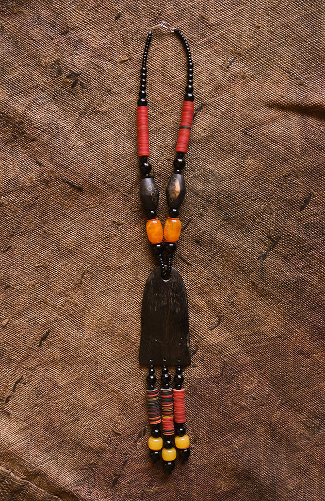 Handcrafted Necklaces - Handmade - African Art - Jewelry - Beaded Necklaces - This Tribal Beaded Necklace is the perfect combination of stylish and timeless elegance. It's handmade with Carnelian beads and African Tribal Jewelry, and features a beautiful wood pendant that adds a classic touch. Wear this necklace and make a bold statement every time.  Length: 16