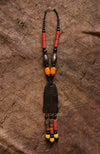 Handcrafted Necklaces - Handmade - African Art - Jewelry - Beaded Necklaces - This Tribal Beaded Necklace is the perfect combination of stylish and timeless elegance. It's handmade with Carnelian beads and African Tribal Jewelry, and features a beautiful wood pendant that adds a classic touch. Wear this necklace and make a bold statement every time.  Length: 16"  Inventory # 10857