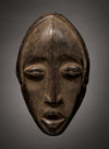 Tribal Masks - Handcrafted - Dan Masks - Traditional Folk Art - African Artifacts Sculptures - African Art Collector - This Carved Wooden Deangle Dan Mask is an authentic work of African art from the regions of Liberia or Ivory Coast, making it an ideal addition to any art collection. Made of wood, this mask features intricate carvings, perfect for showcasing its age and authenticity. Heigh: 9.5 inches Width: 5.5 inches