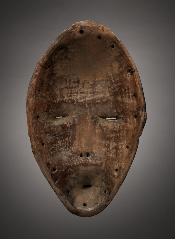 Tribal Masks - Handcrafted - Dan Masks - Traditional Folk Art - African Artifacts Sculptures - African Art Collector - This Carved Wooden Deangle Dan Mask is an authentic work of African art from the regions of Liberia or Ivory Coast, making it an ideal addition to any art collection. Made of wood, this mask features intricate carvings, perfect for showcasing its age and authenticity. Heigh: 9.5 inches Width: 5.5 inches