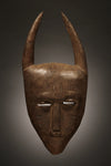 Tribal Masks - Handcrafted - Djimini Masks - Traditional Folk Art - African Artifacts Sculptures - African Art Collector - This authentic hand-carved Ligbi Djimini wood mask is a beautiful representation of West African art. Intricately detailed with exquisite craftsmanship, this piece adds timeless tribal charm to your home decor. Enjoy an exquisite piece of art that will stand out for years to come.