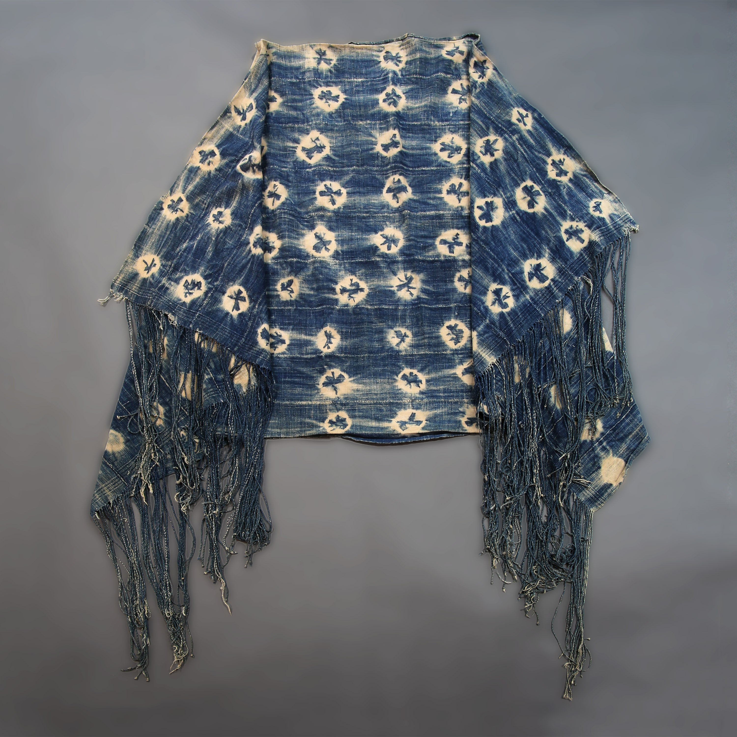 Handcrafted Textiles - Artisan Designed - Handcrafted African Art Textiles - Home Decor - Living Spaces - Mix Colors - Bold Patterns - Traditional Designs - African Culture - This Faded Indigo Scarf Tie Dye Fabric is a vintage African textile shawl that combines a signature faded blue hue with classic tie dye pattern. Crafted from high-quality fabric, this shawl is sure to bring a timeless style to your wardrobe. 60