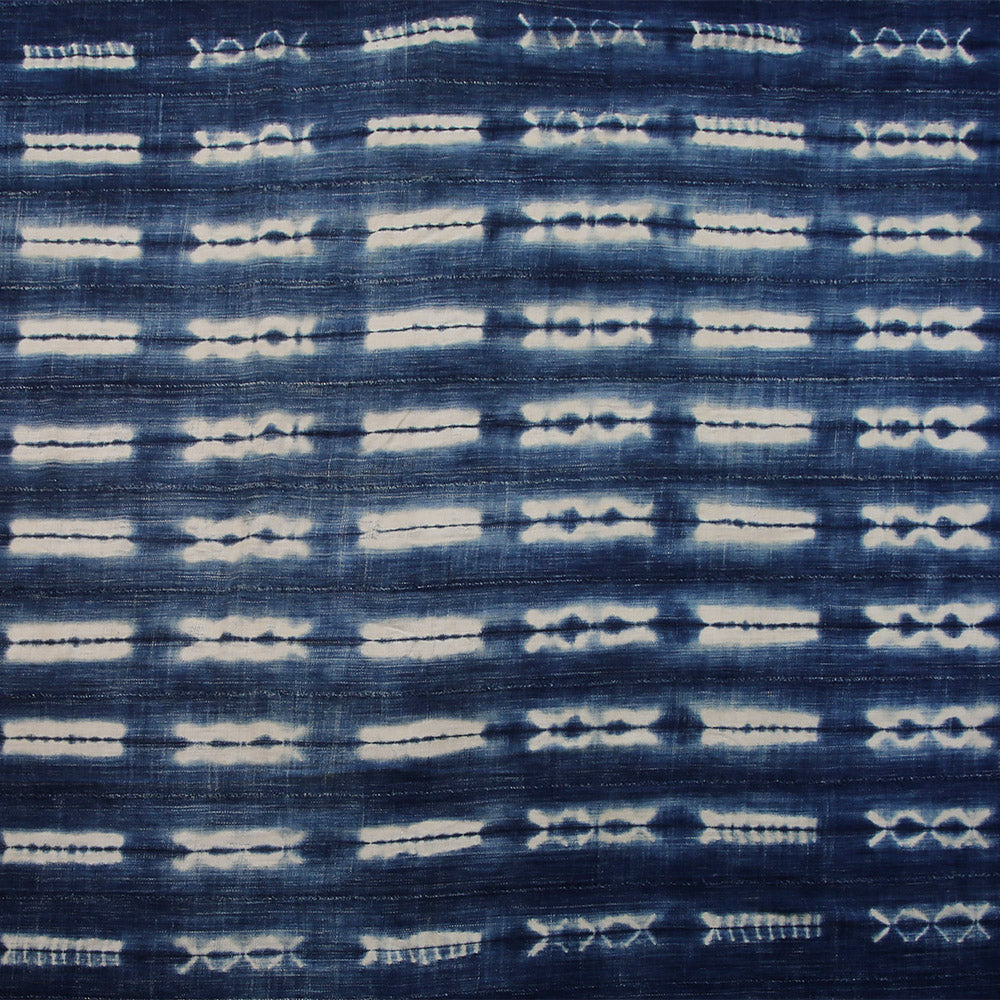 Handcrafted Textiles - Artisan Designed - Handcrafted African Art Textiles - Home Decor - Living Spaces - Mix Colors - Bold Patterns - Traditional Designs - African Culture - This Dyed Indigo Blue White Vintage Cloth is perfect for home decor projects. It's made from a high-quality African Mossi cotton fabric tie-dyed with a Shibori Indigo dye. The blue and white pattern creates a stunning effect that will elevate any space. 74 