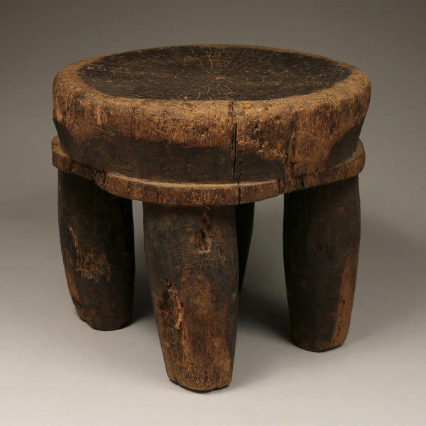 Tribal Furniture - African Art - Home Decor - African Stools - Chairs - Traditional Furniture - Collectible Art - This unique Old Low Stool is crafted from wood originating from the Senufo Tribe of the Ivory Coast. It is an authentic, handmade piece of cultural history, and will become a treasured addition to any home. Height: 10" inches / Width: 10 inches Inventory # 10827
