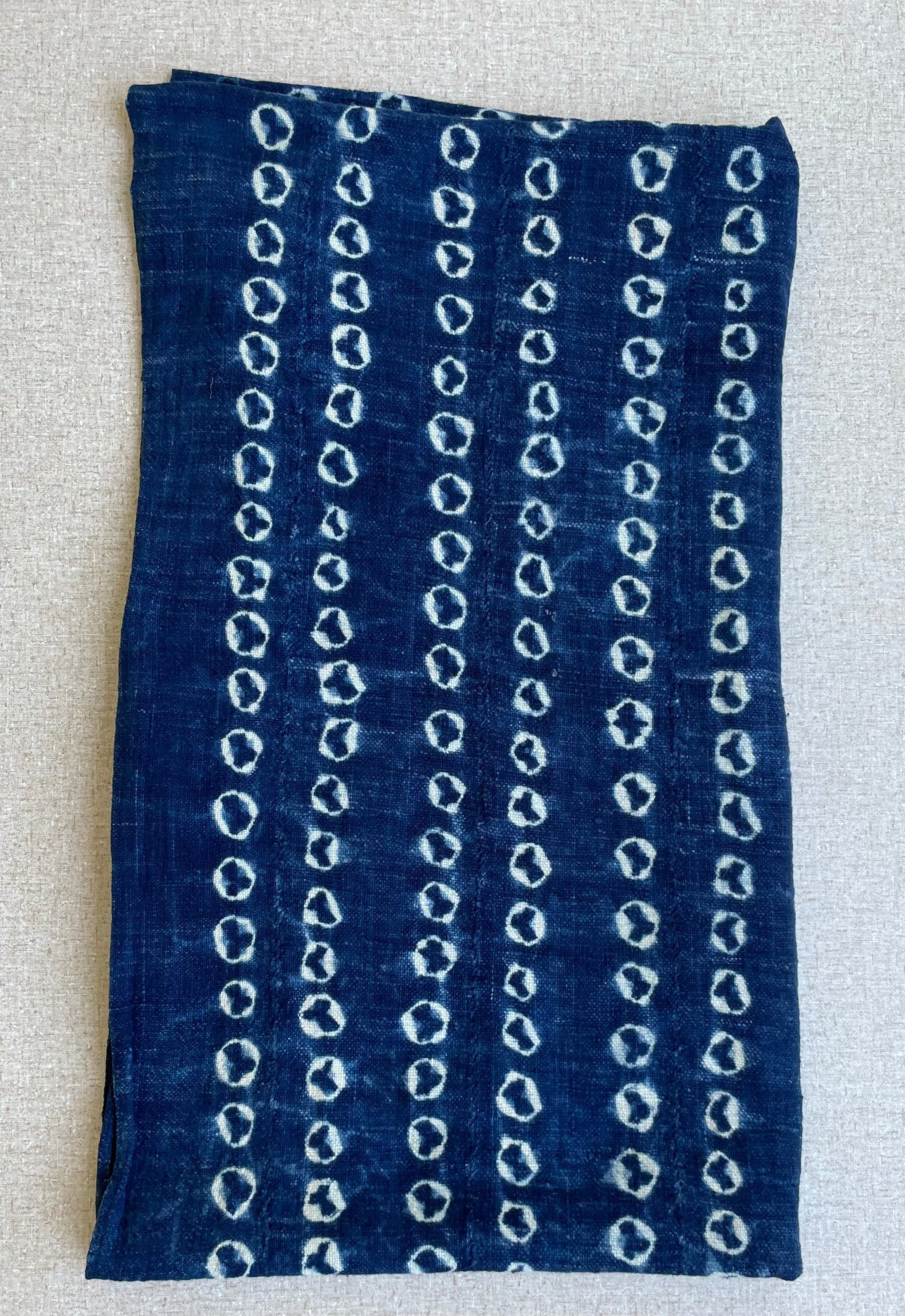 Handcrafted Textiles - Artisan Designed - Handcrafted African Art Textiles - Home Decor - Living Spaces - Mix Colors - Bold Patterns - Traditional Designs - African Culture - This Indigo Shibori Tie Dye Cotton Fabric is a stunning combination of African textile and hand-dyed color. Expertly crafted with attention to detail, this beautiful scarf provides long-lasting durability and a unique flair to any ensemble.  Length: 63 inches  Width: 24 inches