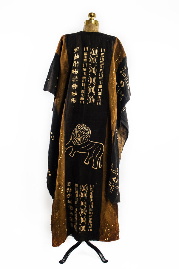 Handcrafted Mudcloth Clothing - African Art - Handmade - Clothing - This Dyed Black Brown Mudcloth Poncho adds a unique, authentic African aesthetic to any ensemble. Crafted with artisanal dying processes and traditional weaving methods, Cotton Bogolan fabric ensures every piece is one-of-a-kind. The natural, handmade look adds an exotic, eye-catching flair to any wardrobe.  Large, Unisex  Full Length: 55"  Inventory # 10715