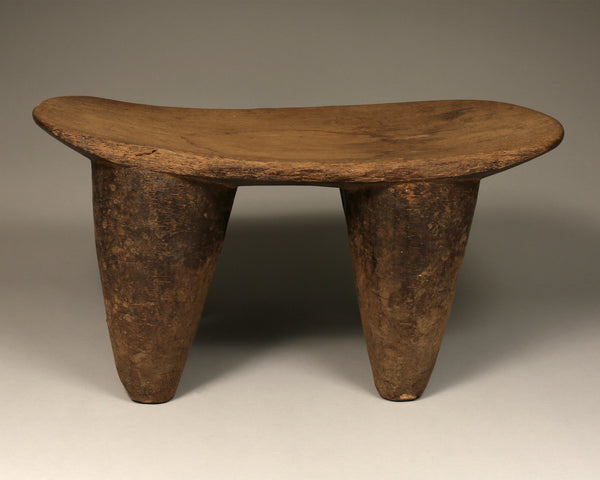 Tribal Furniture - African Art - Home Decor - African Stools - Chairs - Traditional Furniture - Collectible Art - This Old, Authentic Stool is crafted by the Senufo Tribe of the Ivory Coast using natural wood. The unique, vintage design of this stool will add a touch of heritage to your home. Make this piece of history yours today! Length: 20" / Width: 9" Inventory # 10803