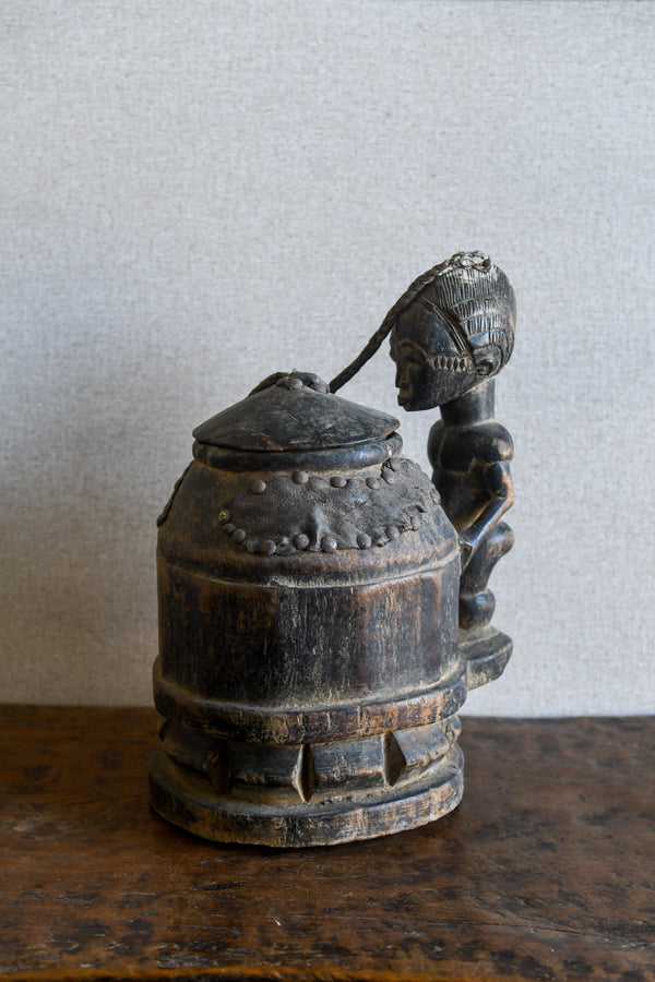 Tribal Objects - African Tribal Art - Ancient Ceremonial Art - Handcrafted Artifacts - Masks - Wood Sculptures - Iron Bronze Objects - Textiles - Art Pieces - African Folk Art - This unique Baule Divination Bowl Figure is an authentic piece of African art. It is an old carved wooden figure, crafted by highly skilled artisans, and is sure to make a statement in any space. The Divination Lidded Vessel Bowl is a perfect addition to any collection of sculptures and objects.Height : 15 inchesDepth: 4 inches