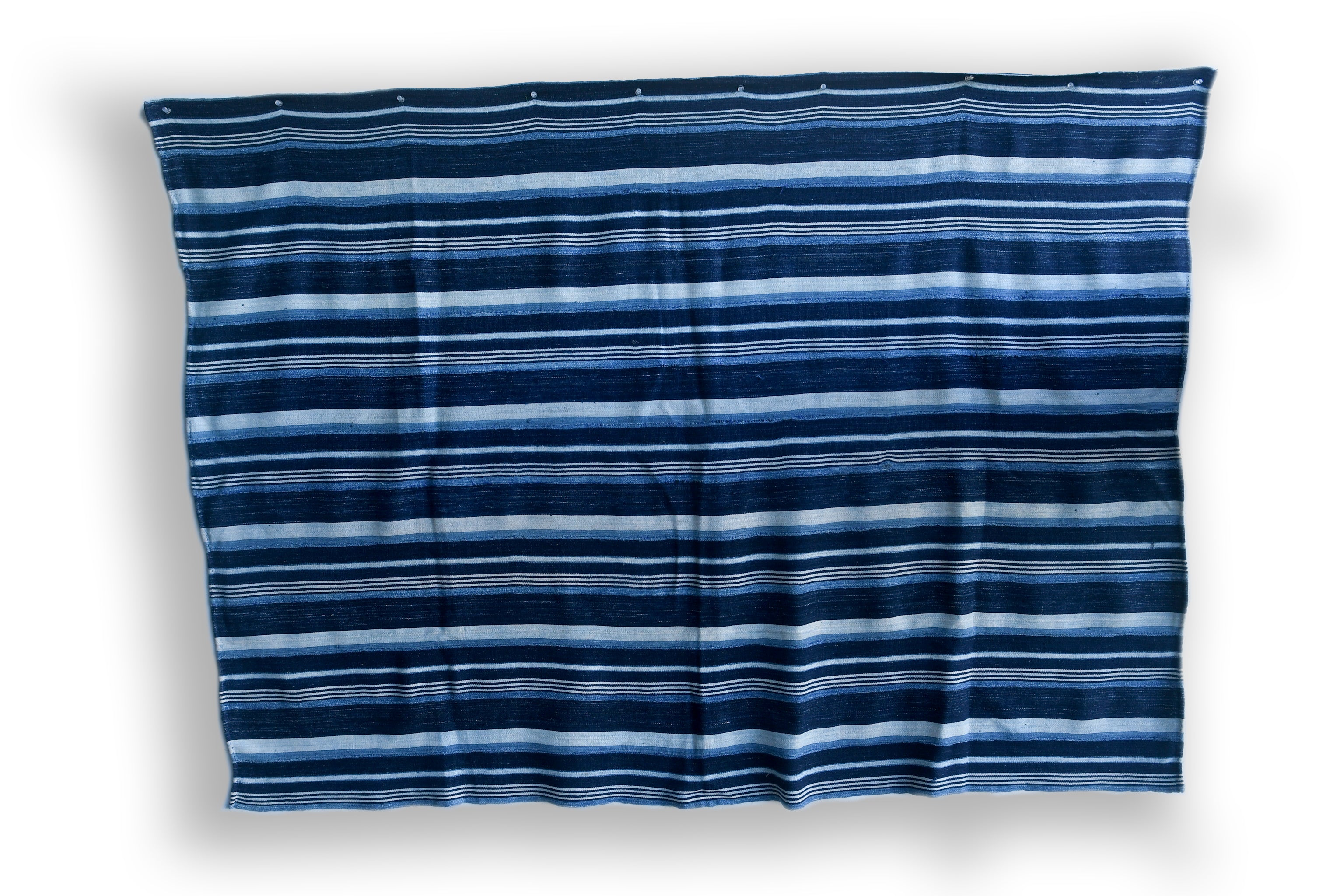 Handcrafted Textiles - Artisan Designed - Handcrafted African Art Textiles - Home Decor - Living Spaces - Mix Colors - Bold Patterns - Traditional Designs - African Culture - This Striped Textile is constructed from Vintage African Cotton material and is distinguished by its Indigo Dyed design. As a home decor accent, it adds a sophisticated yet bold touch to any living space. Length: 62 inches Width: 43 inches