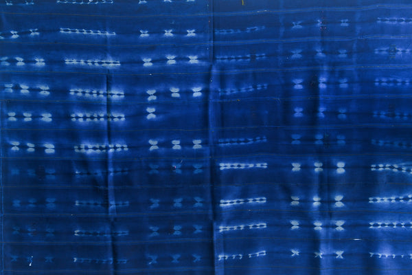 Handcrafted Textiles - Artisan Designed - Handcrafted African Art Textiles - Home Decor - Living Spaces - Mix Colors - Bold Patterns - Traditional Designs - African Culture - This Dyed Baule Ikat Indigo Cotton Cloth is perfect for home décor, bringing African culture to your living room. Hand-crafted with a unique Ikat pattern, this cloth offers beauty and durability, making for a stunning and long-lasting piece of decor. Length: 56 inches Width: 40 Inches
