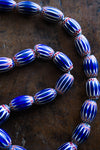 Tribal Trade Beads - African Trade Beads - Tradition - African Decorative Beads - Chevron Millefiori - Krobo - Feather - Melon - King Eye - African Culture - History - Jewelry Making - This Chevron Millefiori African Art Necklace is a stunning piece of jewelry crafted from large Venetian glass trade beads. The Chevron design is an intricate and ancient pattern that has been admired for centuries. Collectors and fashion-lovers alike will appreciate the historical  and craftsmanship of this necklace.