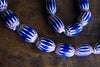 Tribal Trade Beads - African Trade Beads - Tradition - African Decorative Beads - Chevron Millefiori - Krobo - Feather - Melon - King Eye - African Culture - History - Jewelry Making - This Chevron Millefiori African Art Necklace is a stunning piece of jewelry crafted from large Venetian glass trade beads. The Chevron design is an intricate and ancient pattern that has been admired for centuries. Collectors and fashion-lovers alike will appreciate the historical  and craftsmanship of this necklace.
