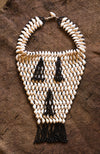 Handcrafted Necklaces - Handmade - African Art - Jewelry - Beaded Necklaces - This Statement Beaded African, Cowrie Shell Jewelry Necklace is an exquisite handmade piece crafted with natural shells and beaded detail. Not only stylish, the necklace is a reminder of the rich culture of Africa and serves as a unique accent to any outfit. Length 11" Inventory # 10824
