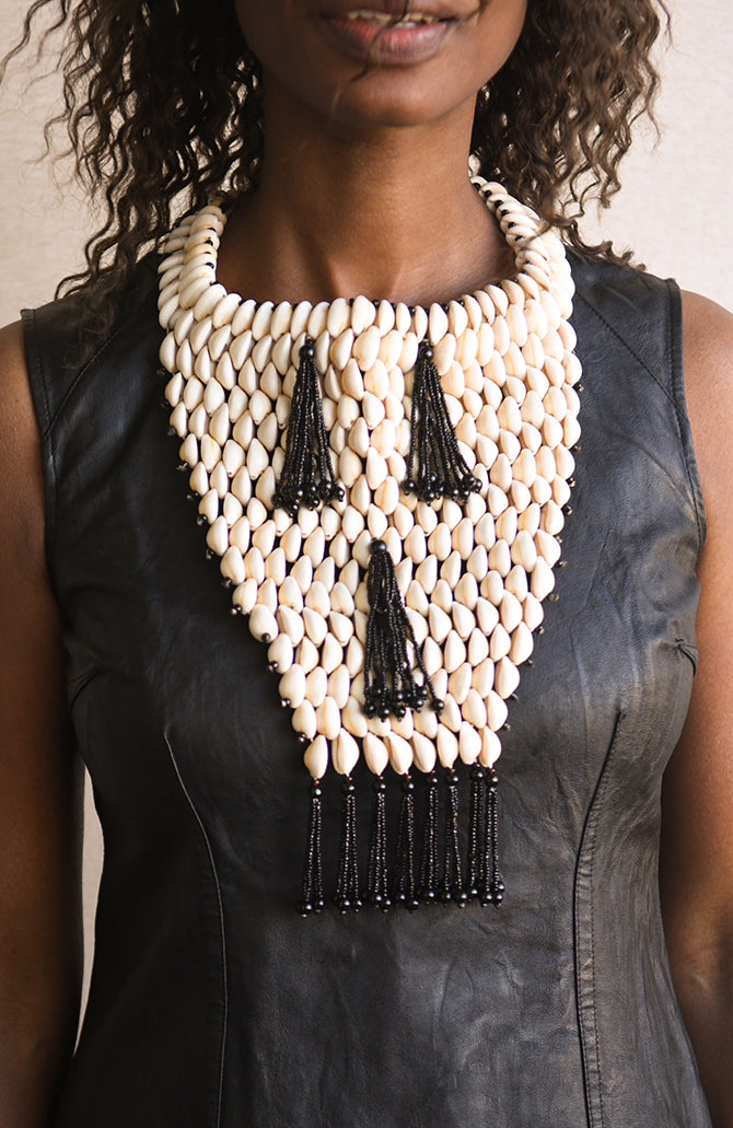Handcrafted Necklaces - Handmade - African Art - Jewelry - Beaded Necklaces - This Statement Beaded African, Cowrie Shell Jewelry Necklace is an exquisite handmade piece crafted with natural shells and beaded detail. Not only stylish, the necklace is a reminder of the rich culture of Africa and serves as a unique accent to any outfit. Length 11