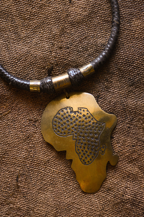 Handcrafted Necklaces - Handmade - African Art - Jewelry - Beaded Necklaces - This beautiful Africa Map pendant necklace is finely crafted from premium leather and bronze. It's perfect for any occasion and adds a unique tribal touch to your wardrobe. The intricate detailing and timeless design will last for years to come! Length: 12" Inventory # 10829