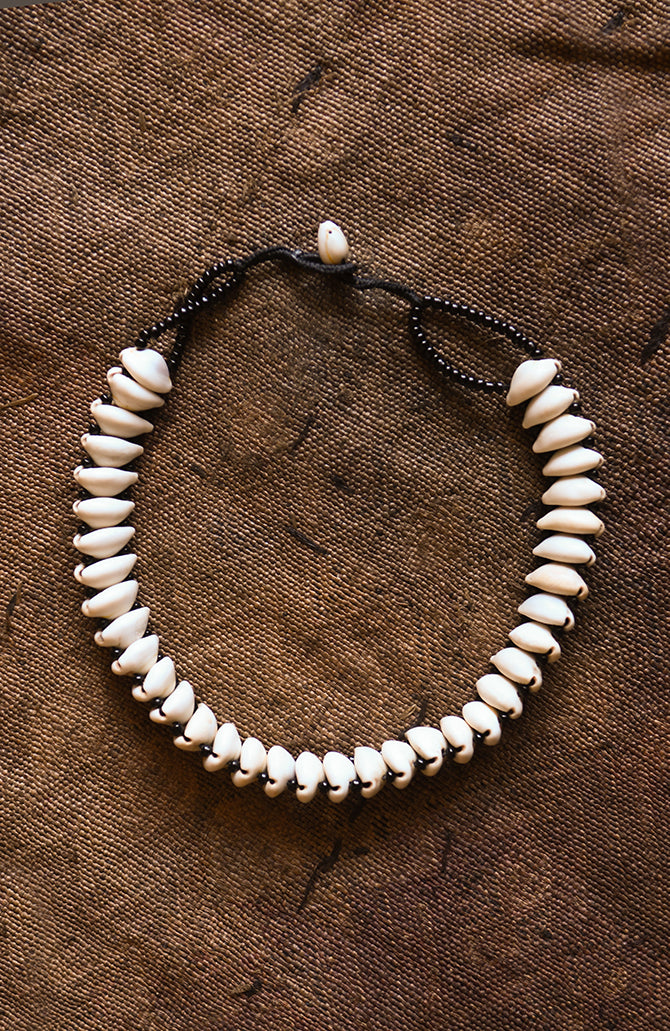 Handcrafted Necklaces - Handmade - African Art - Jewelry - Beaded Necklaces - This African Choker Jewelry is the perfect accessory for the modern woman. Handmade with authentic Cowrie shells, it is sure to add a unique and exotic beauty to your style. Its bold and eye-catching design makes it a timeless piece that can be passed down for generations. Length: 9