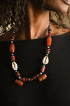 Handcrafted Necklaces - Handmade - African Art - Jewelry - Beaded Necklaces - This handmade Tribal Beads Cowrie Shell Necklace brings an authentic African touch to any look. Its unique design features a beautiful Cowrie Shell pendant and colorful beads perfect for making an eye-catching statement. Length: 11 inches Inventory # 1085