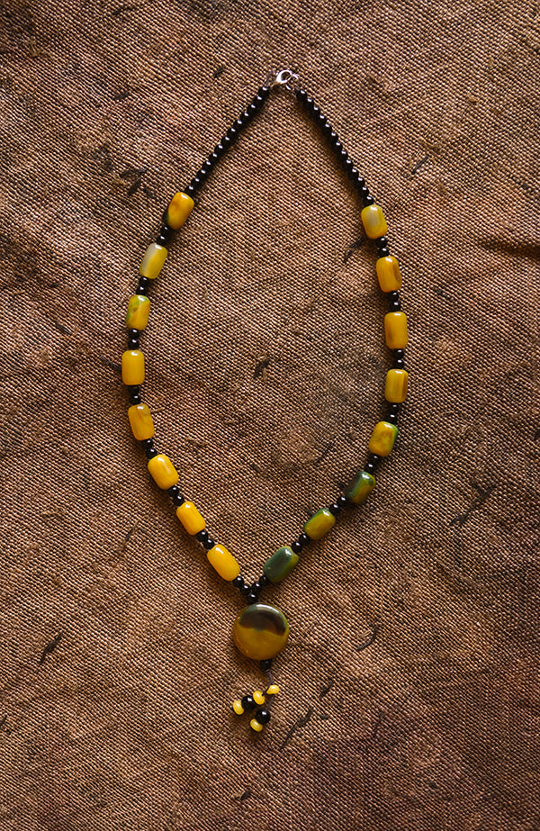 Handcrafted Necklaces - Handmade - African Art - Jewelry - Beaded Necklaces - This Tribal African Necklace features intricately patterned, carved Carnelian Beads carved in the shape of a pendant. Its classic design and bold accents make it perfect for any stylish look. Length: 15" Inventory # 1085