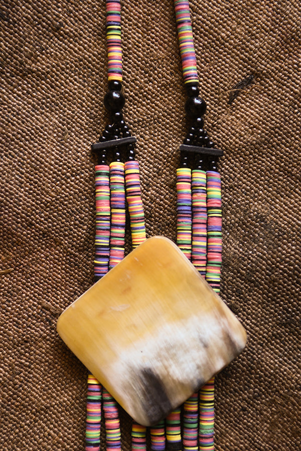 Handcrafted Necklaces - Handmade - African Art - Jewelry - Beaded Necklaces - Make a statement with this gorgeous African tribal necklace. Crafted with hand-beaded jewelry and a carved bone pendant, this necklace will add a unique, eye-catching addition to your look. Length 13" Inventory # 10825